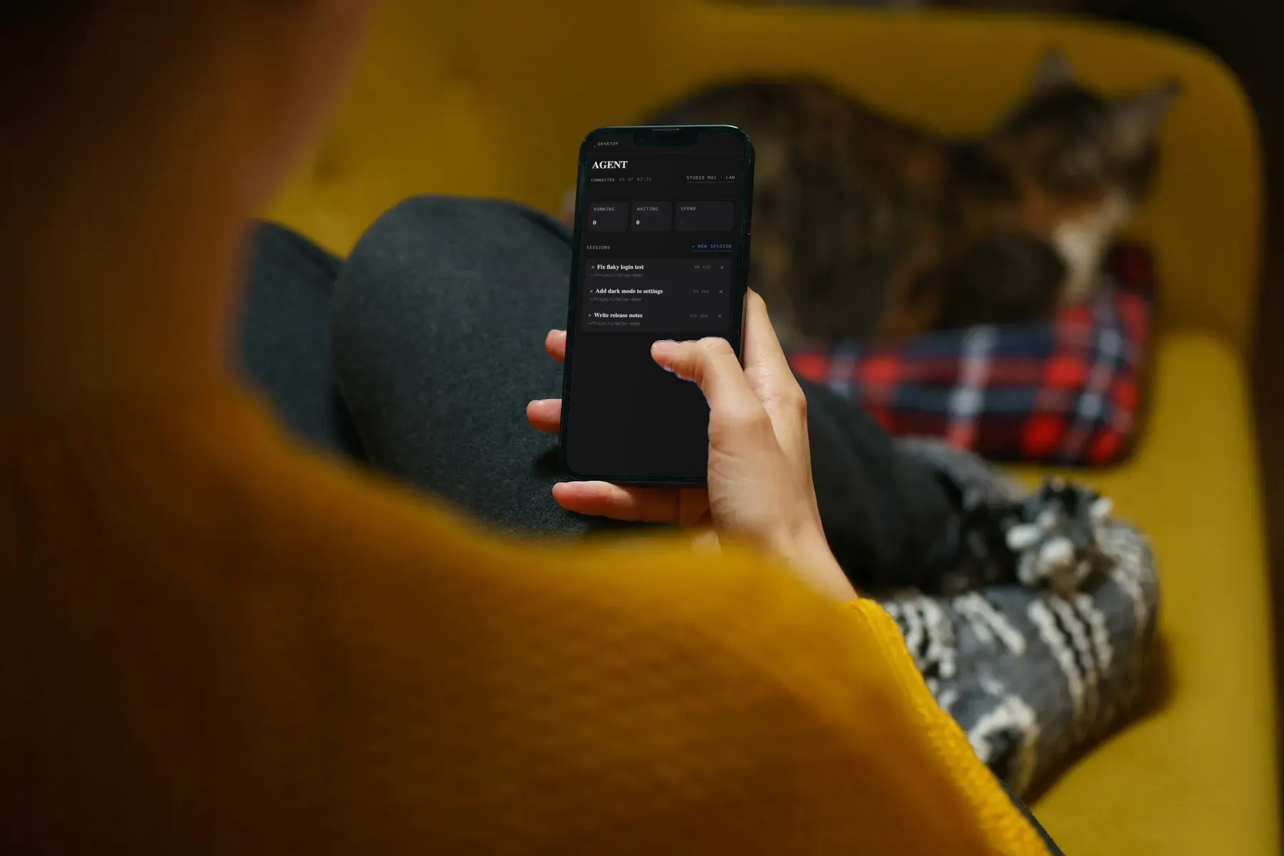 Someone on a couch, phone in hand